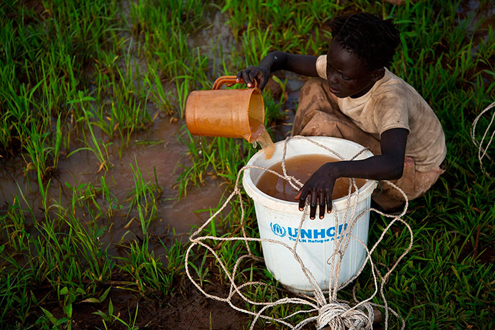 Picture Desk Live: A girl collects water from a puddle at a refugee camp in South Sudan