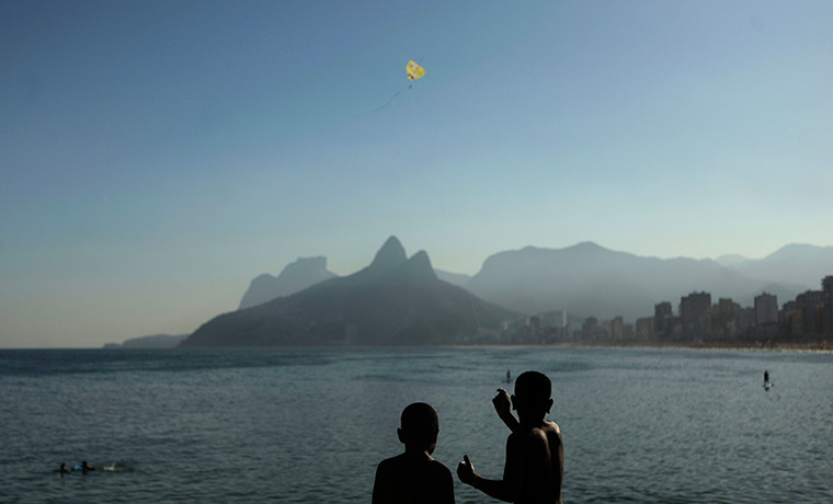 24 hours: Rio de Janeiro, Brazil: Boys fly a kite at Arpoador beach