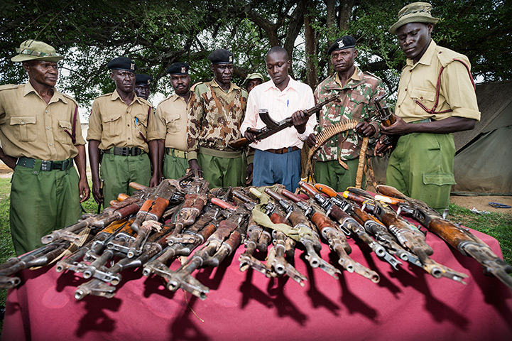 Kenya gun violence: Police officers examining collections of guns