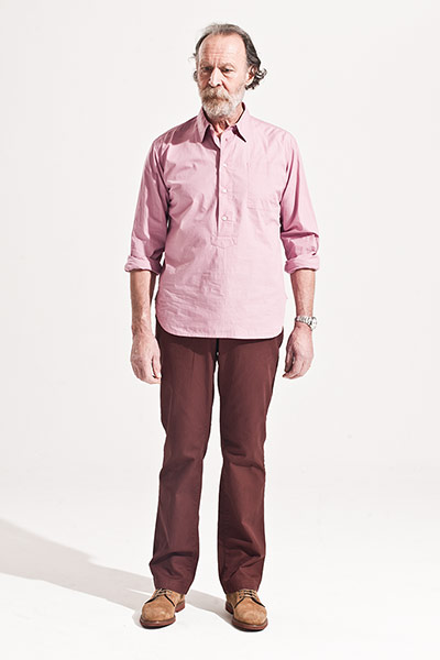 All Ages: Male model wears pink shirt and maroon trousers