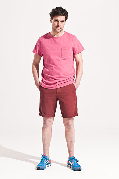 All Ages: Male model wears bright pink t-shirt and dark red shorts