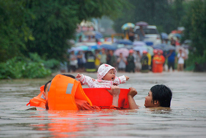 Picture Desk Live: Babies rescued from a standed bus during floods in Hunan, China