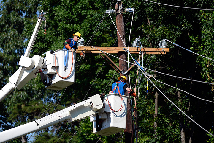 US storms:  A utility crew works on power lines to restore power in Springfield