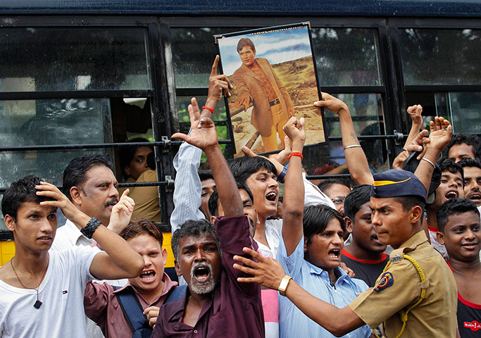 Week in film: Fans hold a framed portrait of Bollywood actor Rajesh Khanna