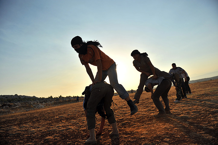 24 hours in pictures: Members of Jihadist group Hamza Abdualmuttalib train near Aleppo 
