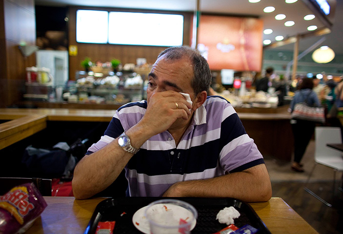 From the agencies: Jose Manuel Abel wipes away his tears as he waits to catch a flight
