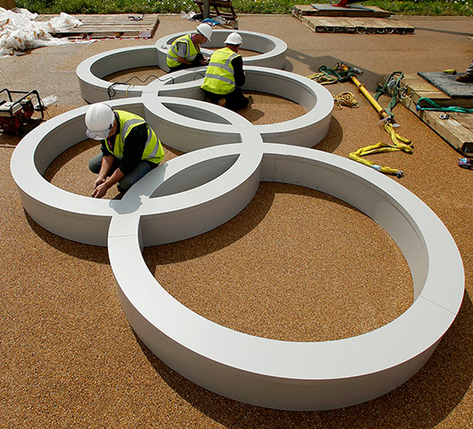 picture desk live update1: Workers assemble a set of Olympic Rings