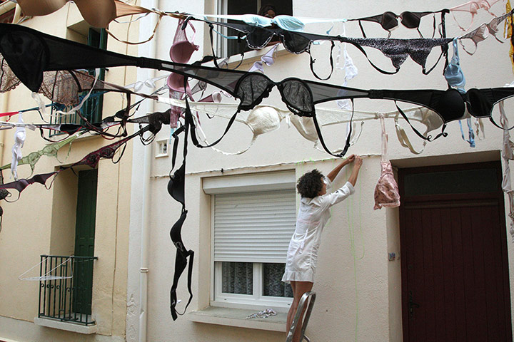 24 hours: A woman places a garland of bras in orde