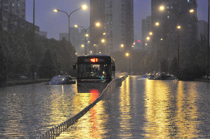Beijing flooding: Vehicles trapped in a flooded street
