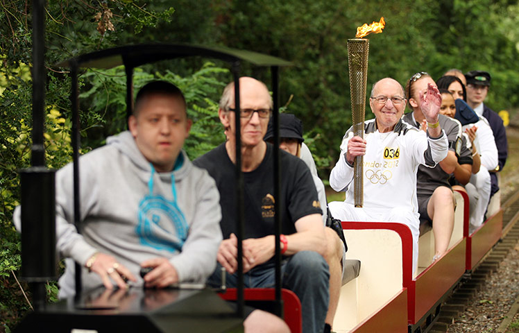 Olympic Torch 65: Paul Freedman MBE  carrying the Olympic Flame 