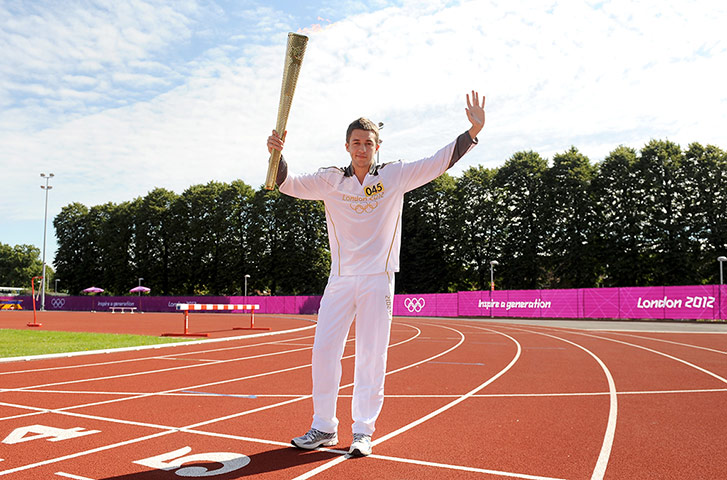 Olympic Torch 65: Scott Emmons carries the Olympic Flame around Mayesbrook Park 