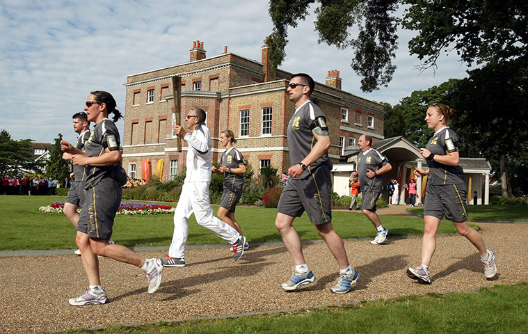 Olympic Torch 65: David Backhouse carrying the Olympic Flame past Valentine's Mansion