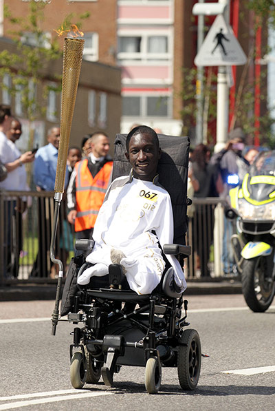 Olympic Torch 65: Isaac Harvey carries the Olympic Flame on the Torch 