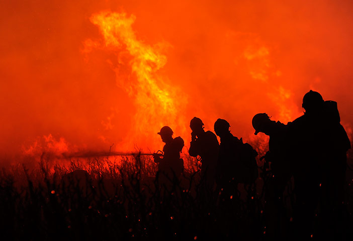 Picture Desk Live: Firefighters try to extinguish a wildfir