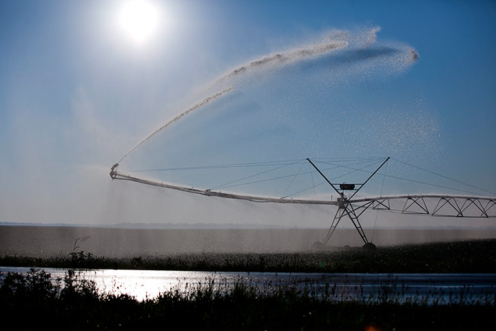24 hours: Eldorado, Illinois, USA: An irrigation system waters drought-striken field 