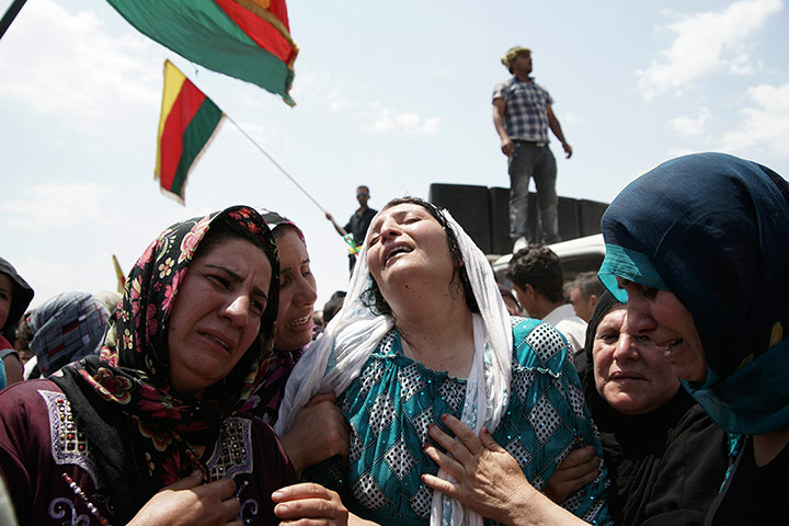 Picture Desk Live: The Kurdish civil guard at a roadblock with Syria