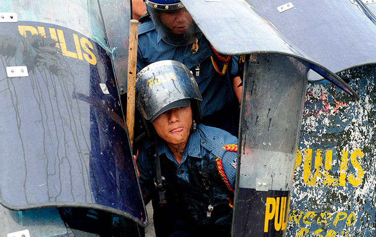 Picture Desk Live: Policemen hide under their shie