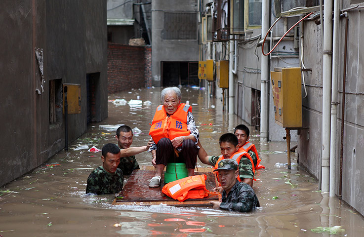 Picture desk live: Rescuers evacuating an elderly woman China