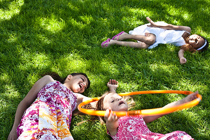 Brita garden games: Girls lying on grass with hula hoops