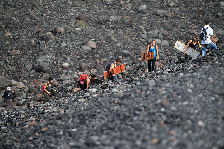 24 hours in pictures: Tourists scale the Cerro Negro volcano to surf