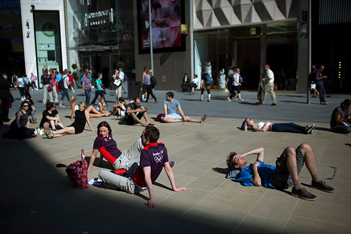 24 hours in pictures: People rest in a square near to the Olympic Park