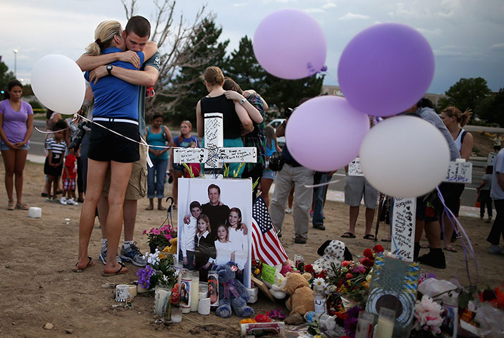 Picture desk live: Families of shooting victims gather at the makeshift memorial  in Aurora