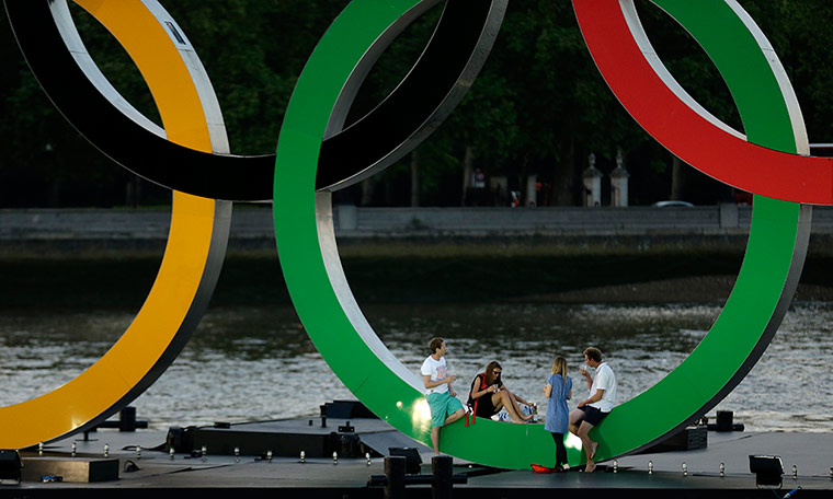Picture desk live: A group sit on a set of Olympic Rings