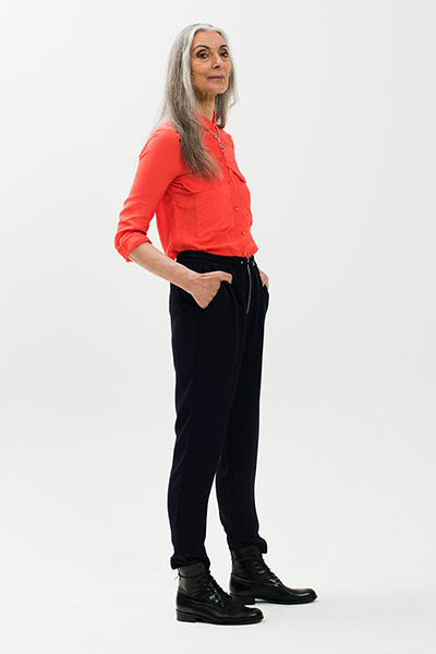 All Ages: Model wears a red shirt and black trousers
