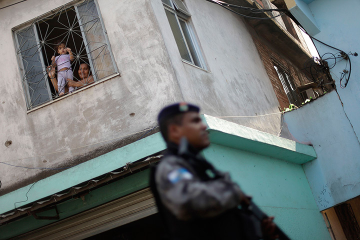 24 hours: Rio de Janeiro, Brazil: A woman holds her child to the window