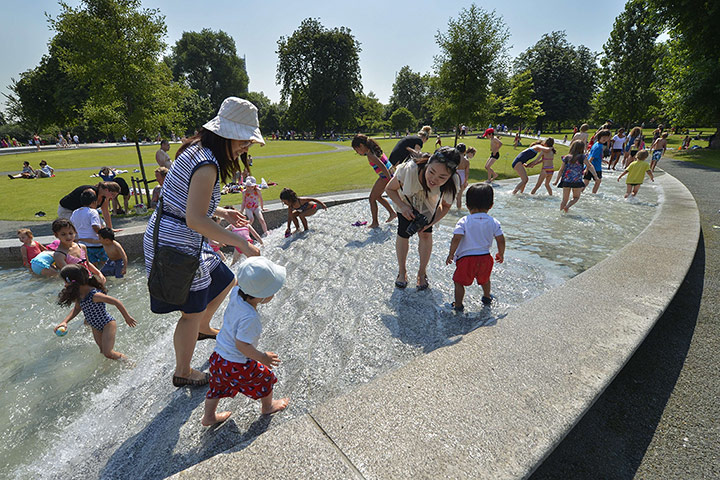 Picture desk live: People enjoy a paddle at the Diana Memorial Fountain in London's Hyde Park