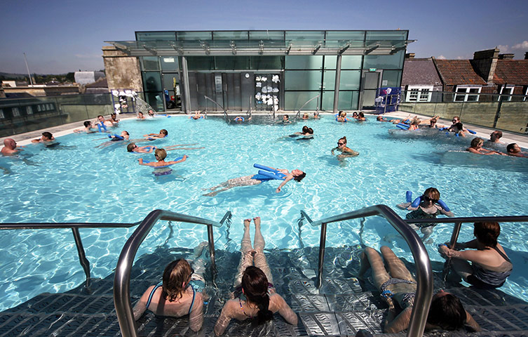 Picture desk live: People soak up the sun at the rooftop pool at the Thermae Bath Spa in Bath