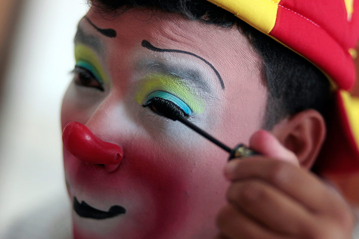 Picture desk live: A clown called Titi applies make up 