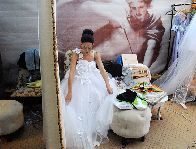 24 hours: Kiev, Ukraine: A disabled model prepares backstage at a fashion show 
