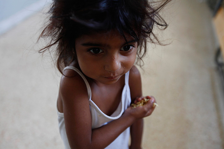 24 hours: Marj, Lebanon: A young Syrian girl eats noodles in a government school