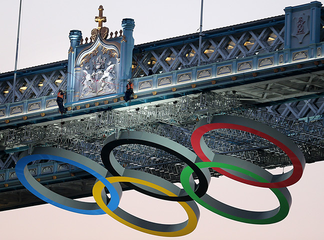 Olympic week build up: Workmen check the The Olympic Rings hon Tower Bridge