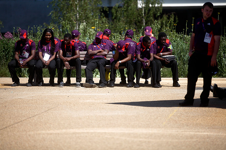 Olympic week build up: Volunteers take a break on a bench at the Olympic Park