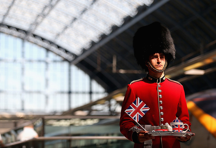Olympic week build up: A Guardsman welcomes passengers at St.Pancras International Station