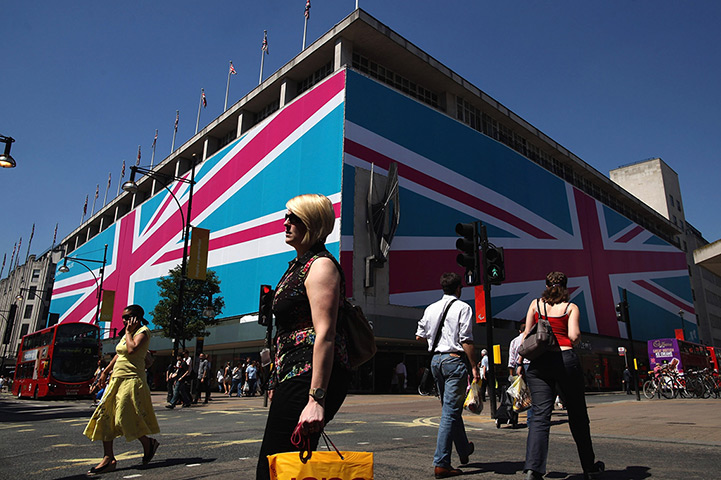 Olympic week build up: Shopper walk past the John Lewis department store, with Union Jack facade