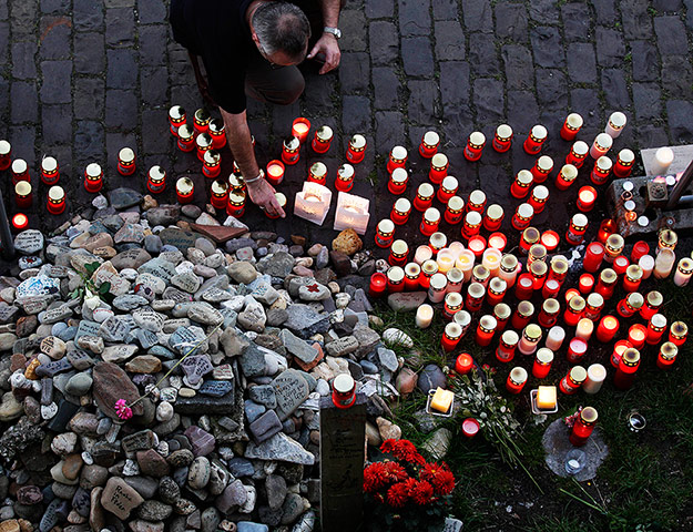 Week in music: A man places a candle in Duisburg, Germany