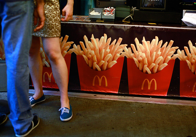 Week in Business: A couple stands in line at McDonald's in New York's Times Square