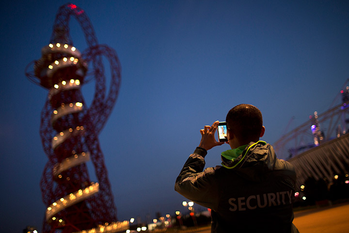 Week in Business: A security member takes photos at the Orbit observation tower