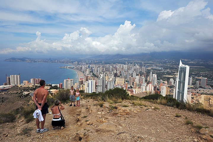 Week in Business: Two children pose in front of the eastern Spanish resort of Benidorm 