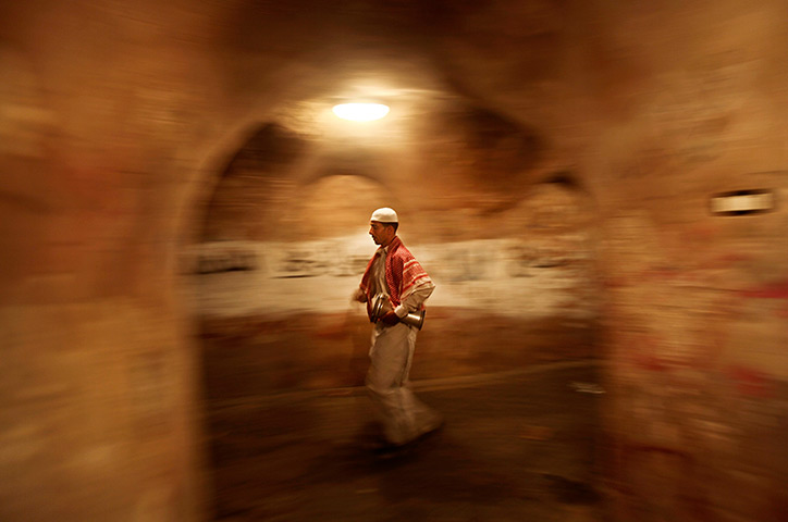 24 hours in pictures: Palestinian Ramadan drummer walks the streets of the old city in Gaza