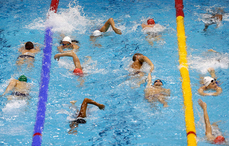 last day for relaxing: Swimmers get a few final laps in at the Aquatics  Centre
