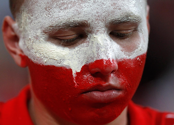Euro picks: Tears create streaks in a fan's face paint after Poland were eliminated