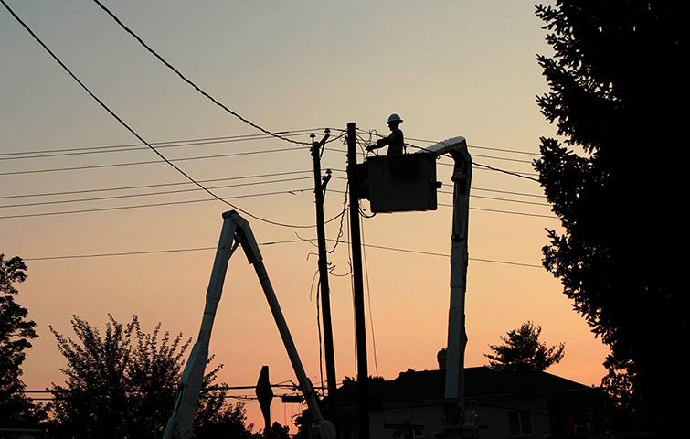 Picture desk live: A worker tries to restore power to a neighborhood of Falls Church, Virginia