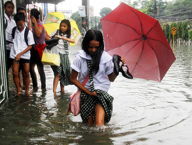 Picture desk live: Students paddle to school in floodwater in Quezon City in the Philippines