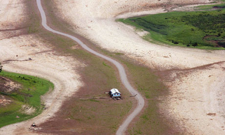 A houseboat lies on a drying river bed in the drought-stricken Brazilian Amazon