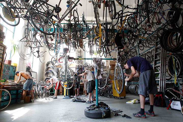 24 hours: Vienna, Austria: People repair bikes at the WUK self-help bicycle workshop