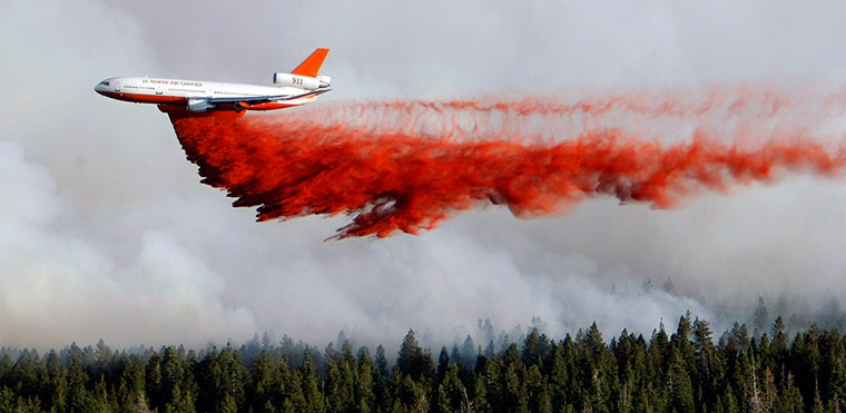 24 hours: Cedar City, Utah, US: A heavy tanker drops retardant on the Shingle Fire